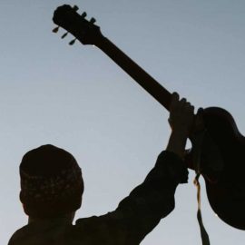 RockmusicRaider - Man with raised guitar - Tanagra wins Trademark Dispute